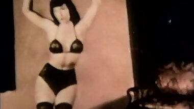 Brunette Witch Entices Audience in Lingerie (1950s Vintage)
